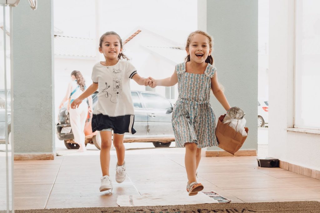 Smiling Girls Holding Hands and Running Together