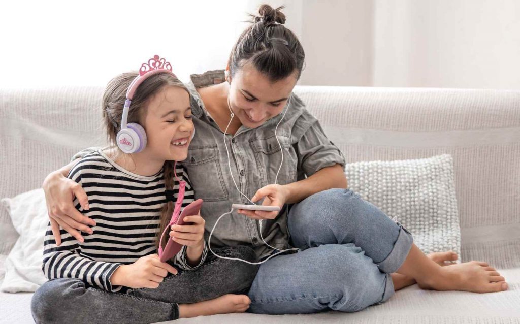 Mother and daughter with a headphone on