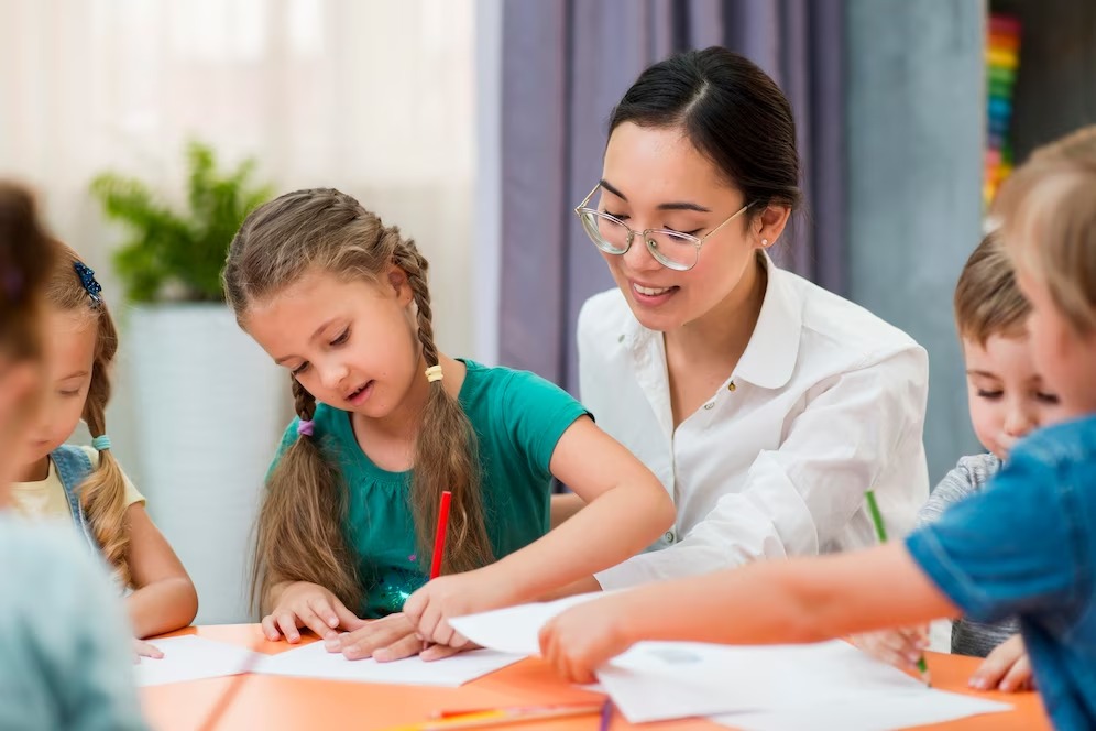 Teacher helping kids in class