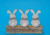 3 wooden bunny figures on a wooden cuboid