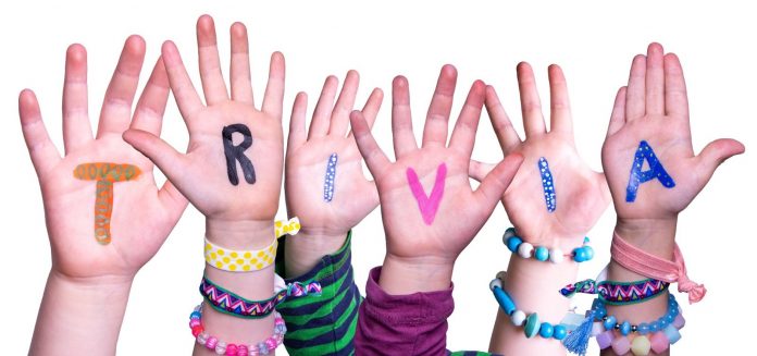 Kids hands with trivia written on them