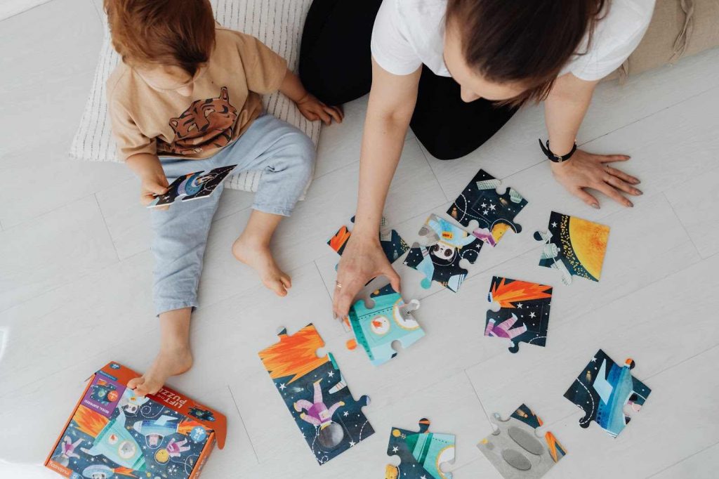 Mother and child playing with jigsaw puzzles