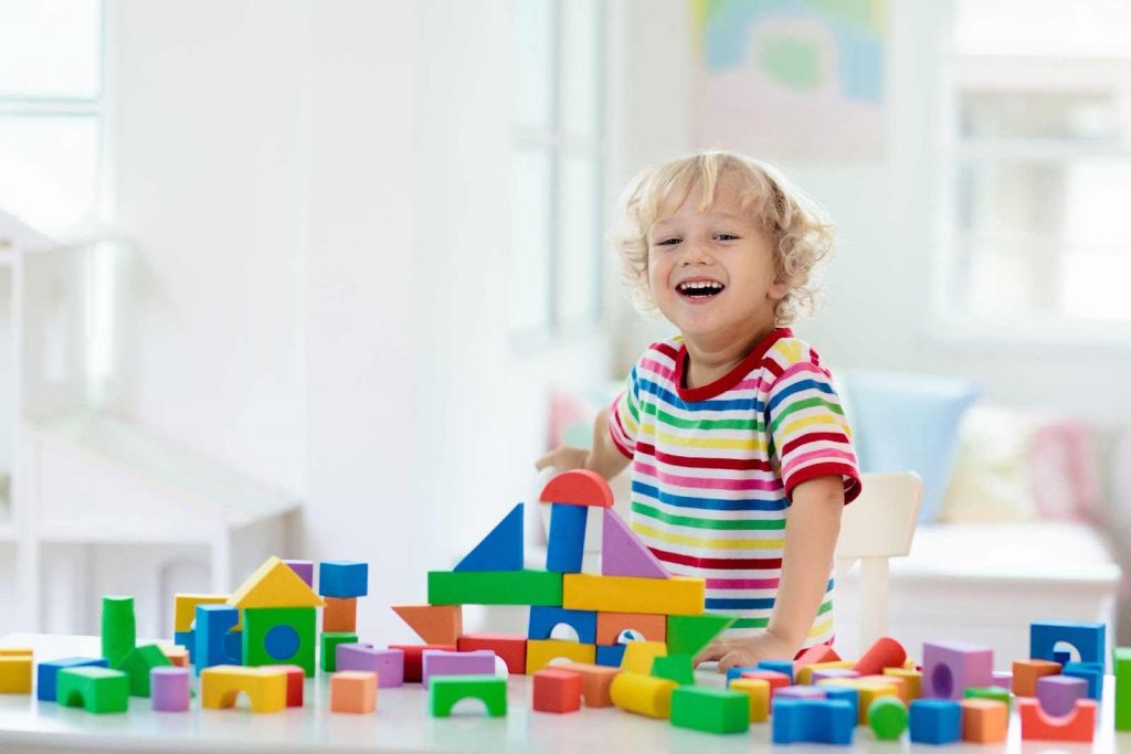 Kid playing with building blocks