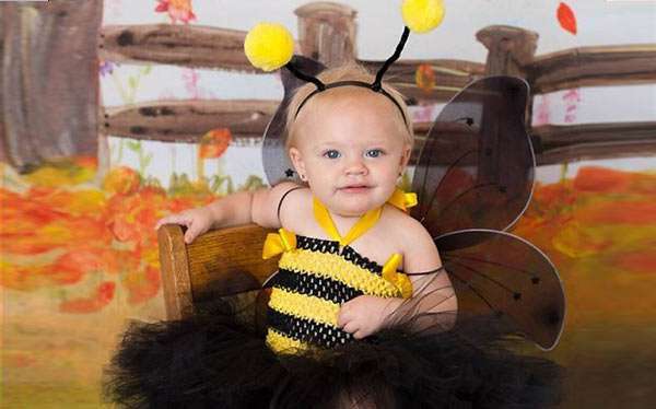 A kid wearing bumble bee costume