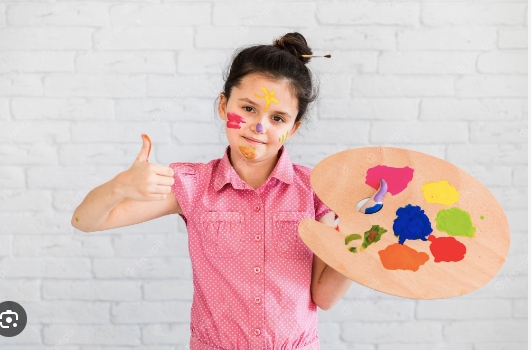 A girl showing her thumb for thumb painting