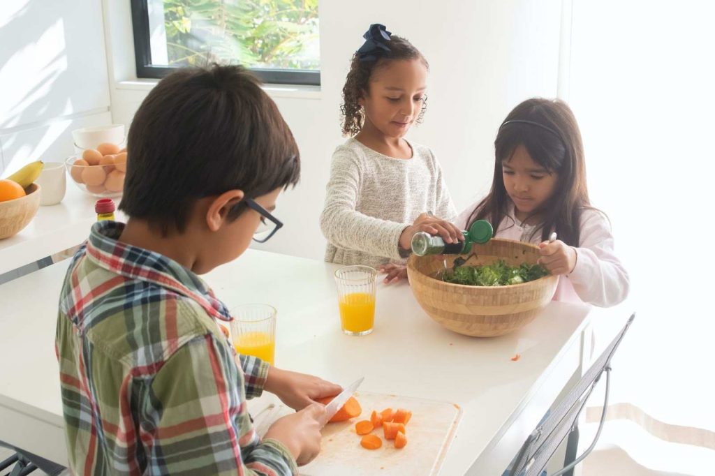 Three children cooking together