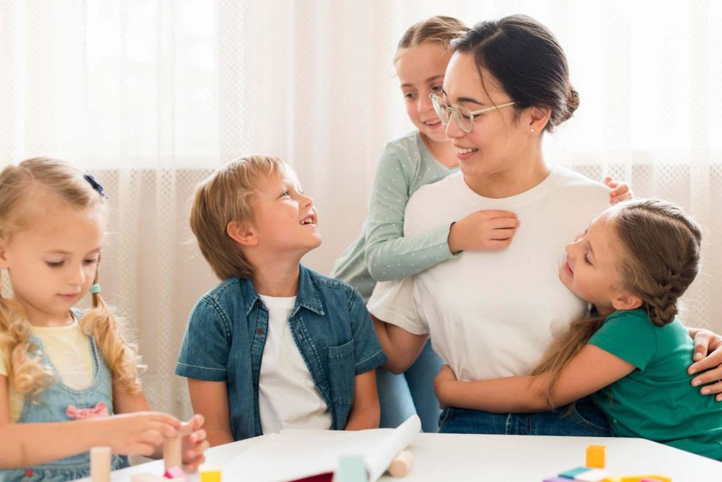 Kids smiling with a teacher