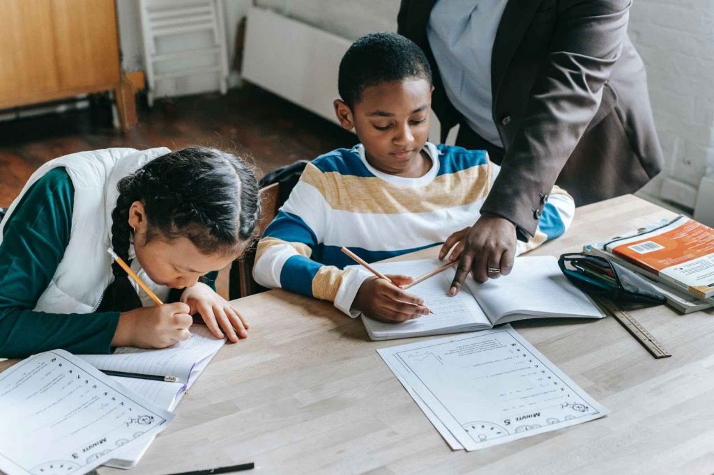 Teacher helping kids with classwork