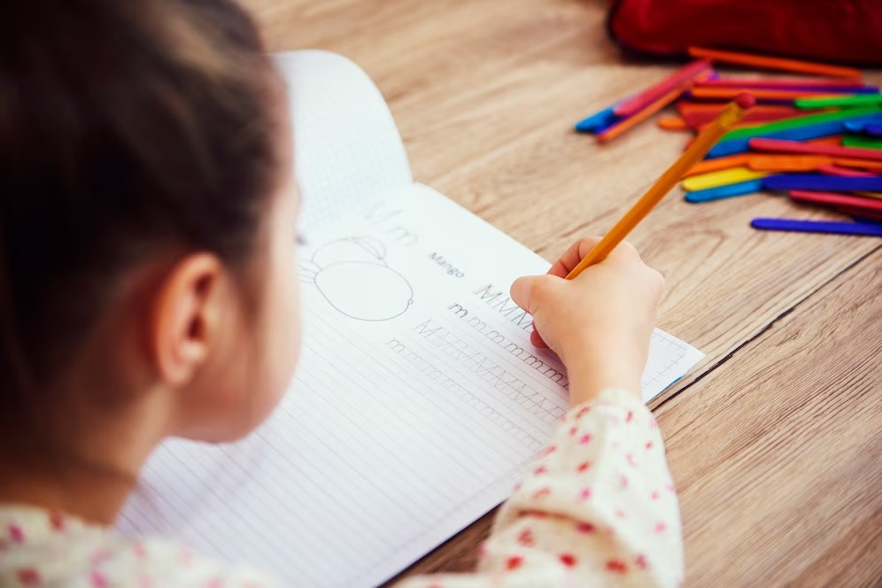 Little girl learning how to write