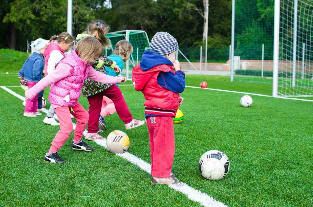 Children playing with footballs