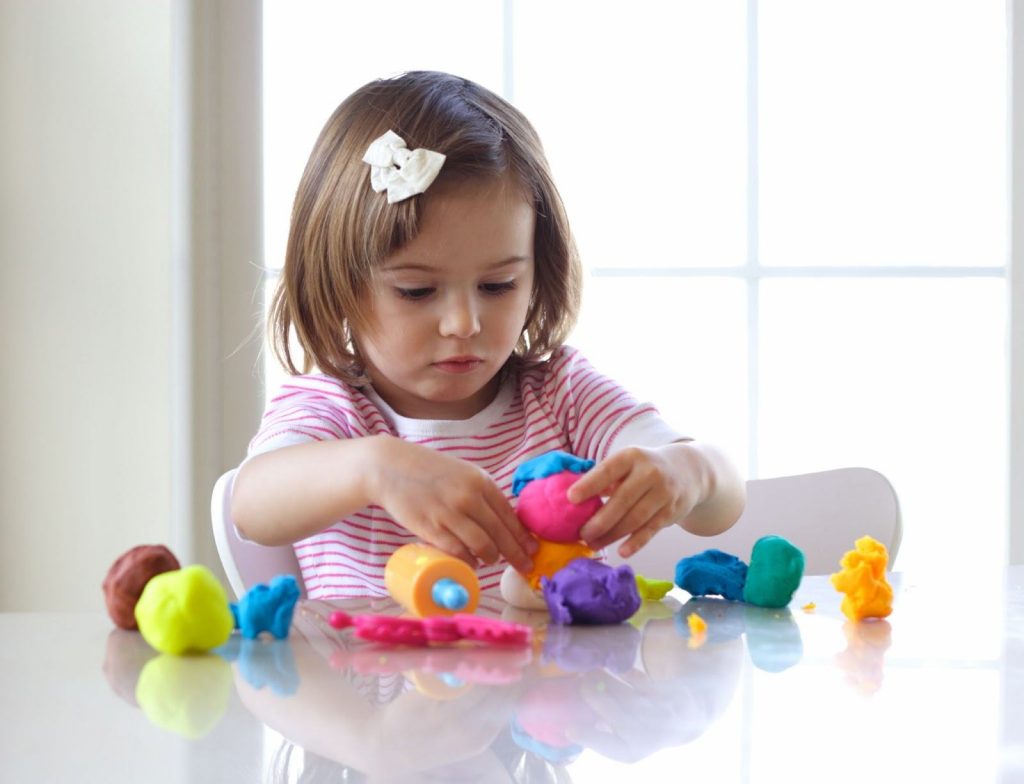 Kid playing with play dough