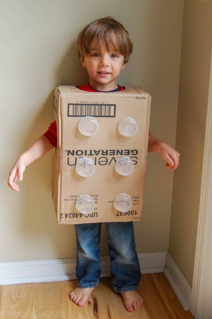 A kid wearing DIY lego costume