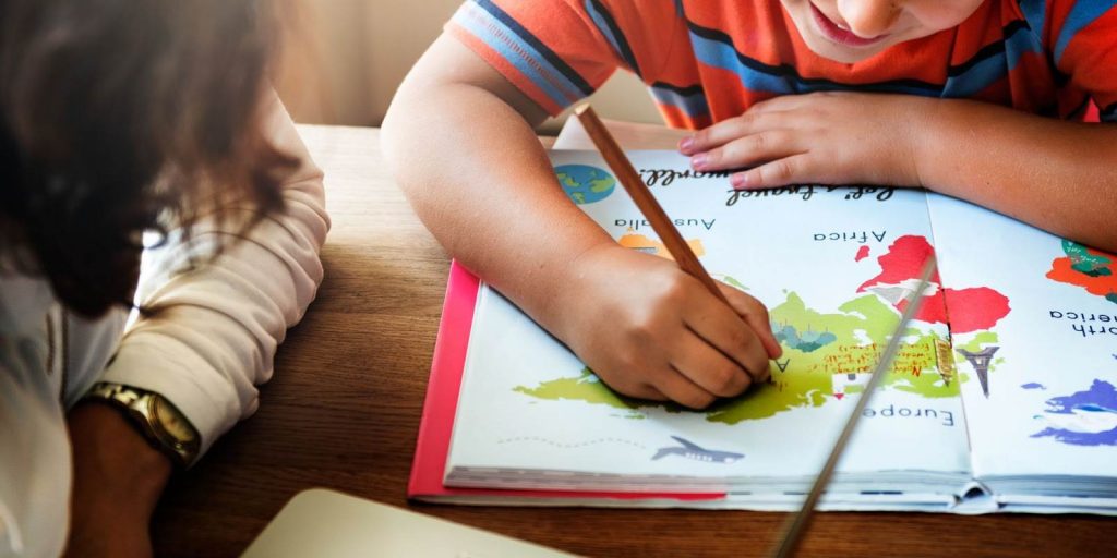 Kid drawing a world map