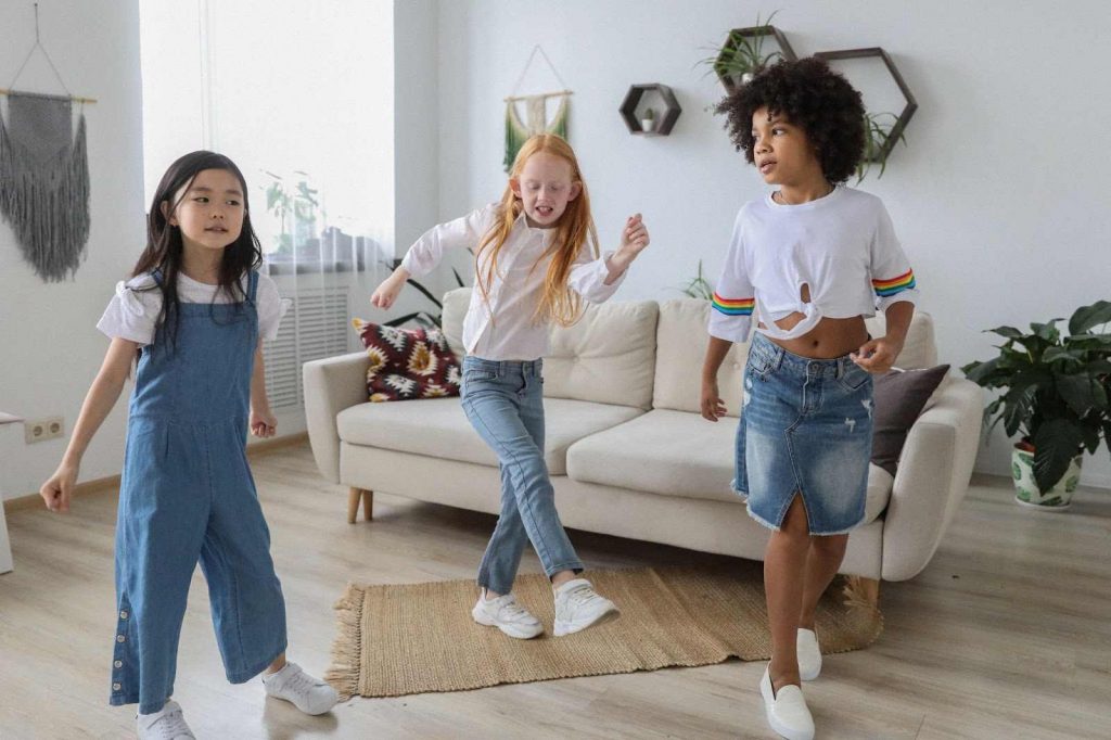 Three little girls dancing together