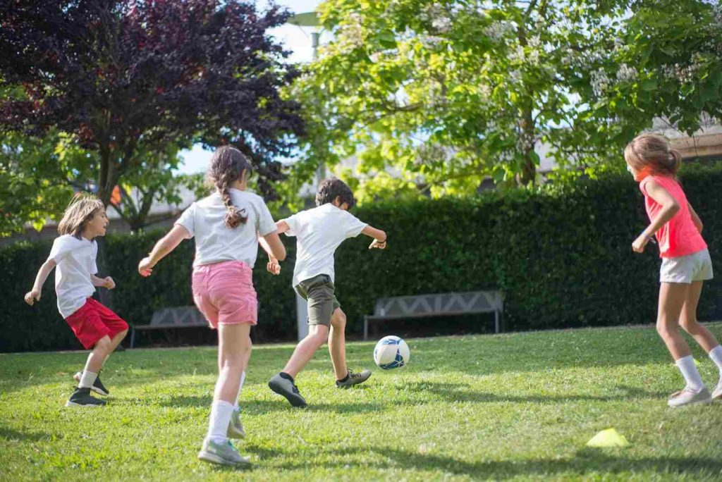 Children playing football in the park