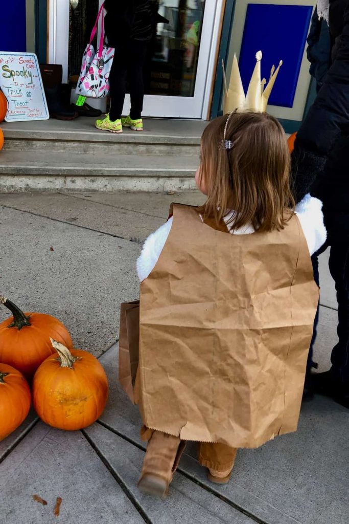 A girl wearing paper bag costume