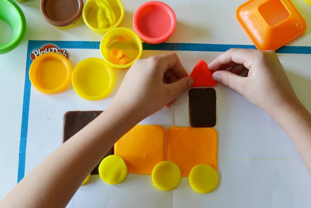 Kids making shapes from playdough