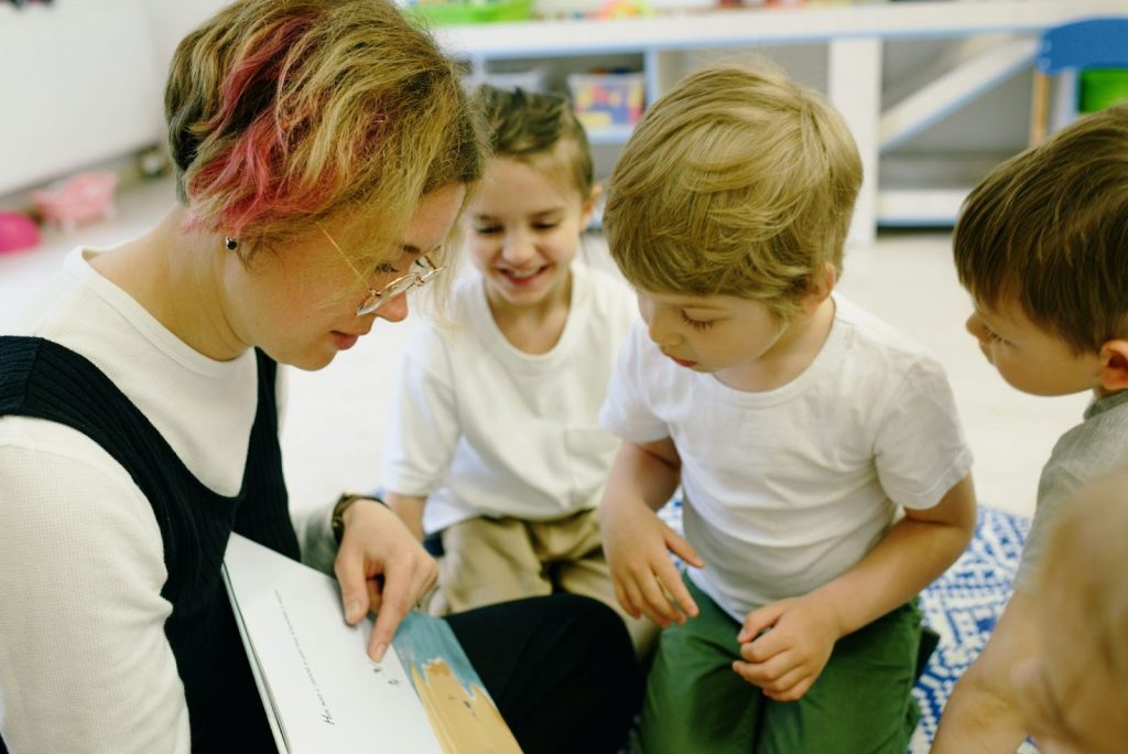 A woman teaching kids how to read