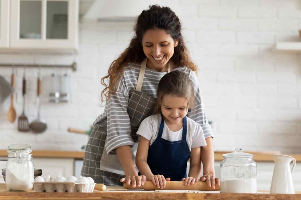 kid cooking with mother