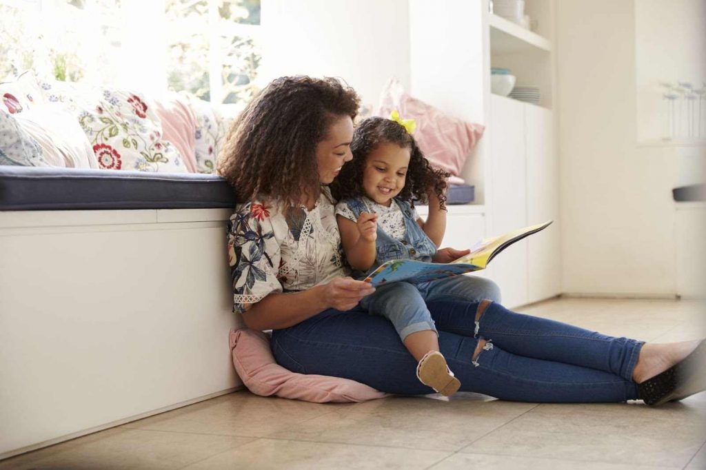 Mother reading to daughter