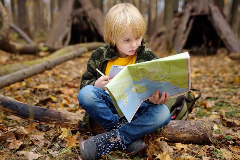 Kid looking at a treasure hunt map