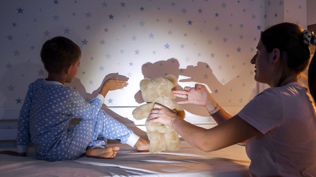 Kid and mother using shadow to make a story