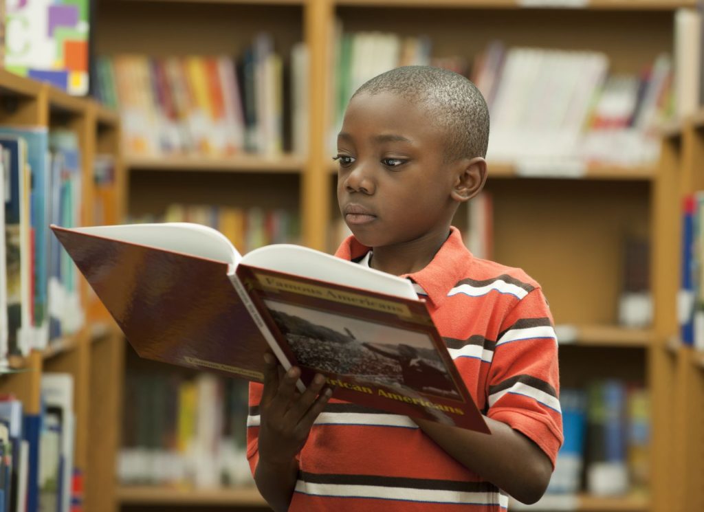 A kid reading history book