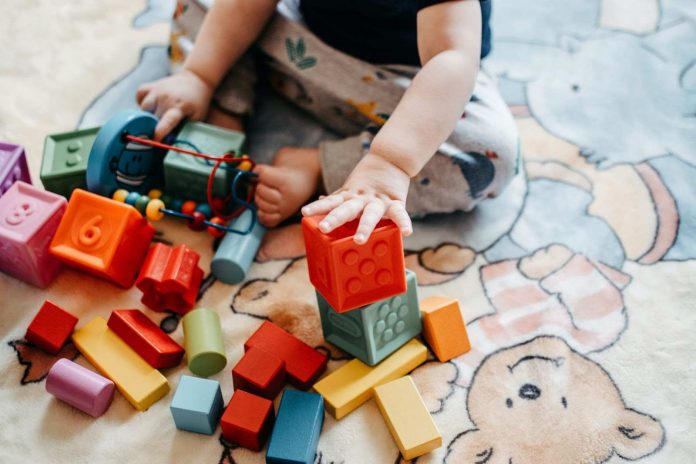 A little child playing with blocks