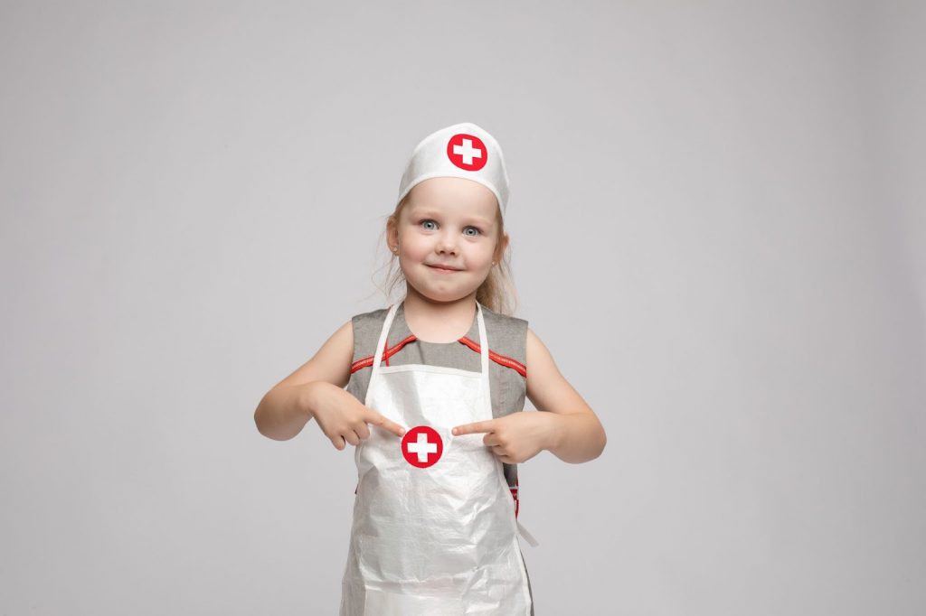 A kid in a nurse dress