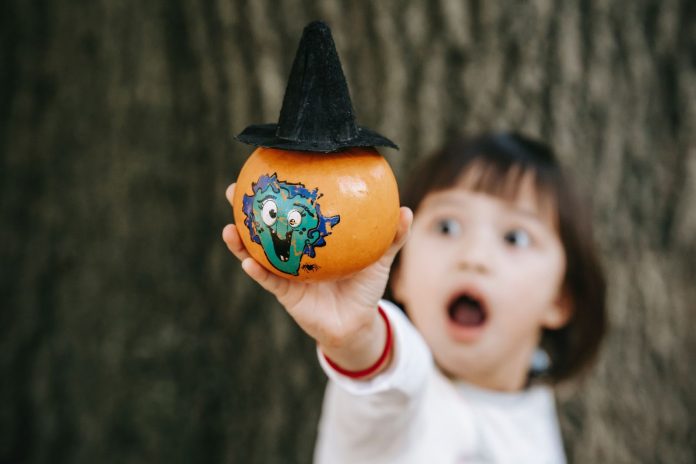 Kid holding a scary painted object