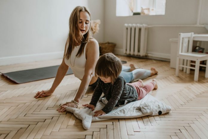 Kid doing yoga with mother