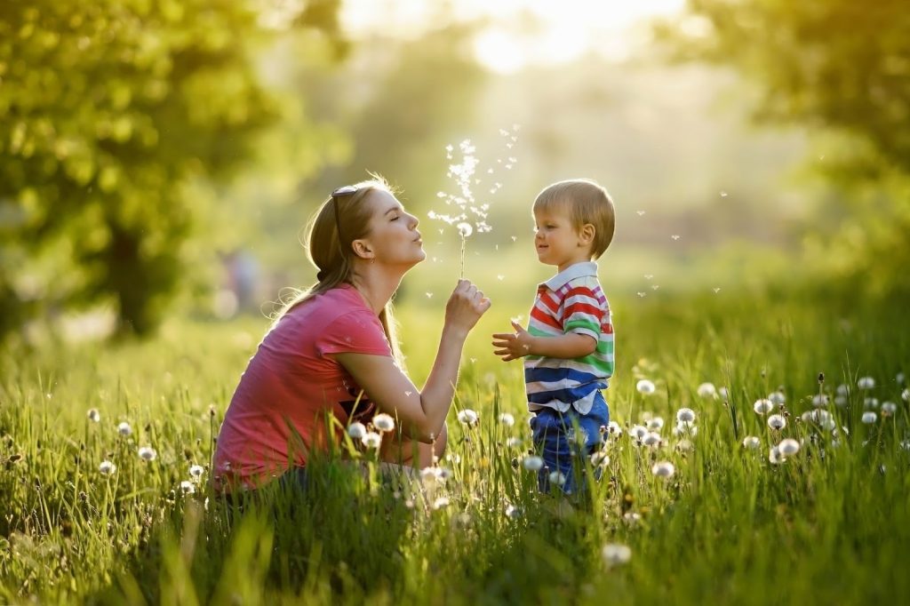 Mother with toddler blowing water bubbles