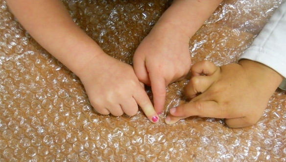 kids popping bubble wrap