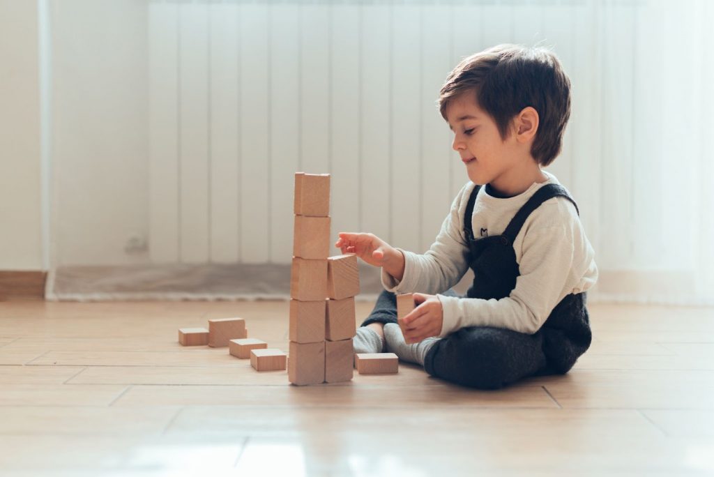 Kid playing with building blocks