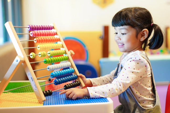 A girl counting an an abacus