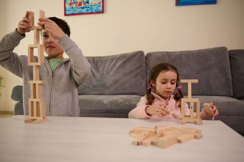 Two kids building a tower