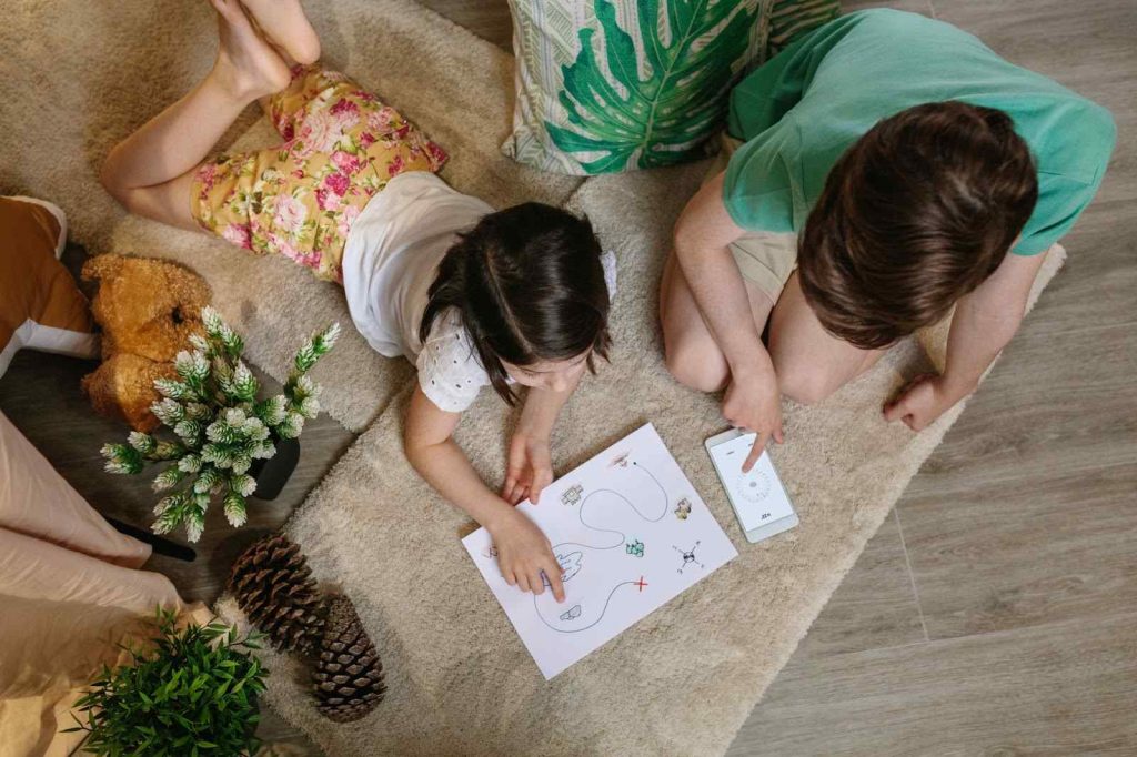 Two kids looking at a treasure hunt map