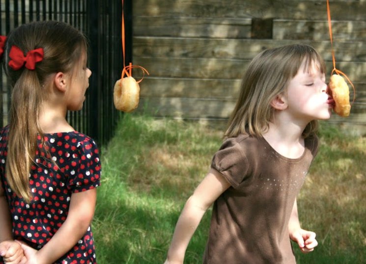 Kids eating hanging donut