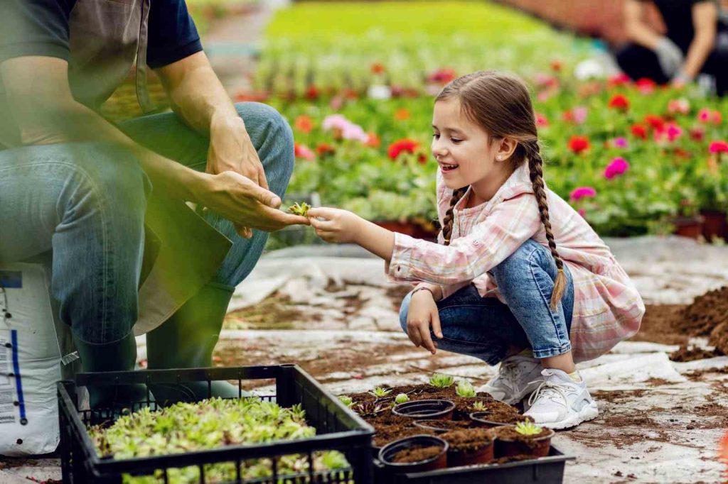 A little girl gardening with her father