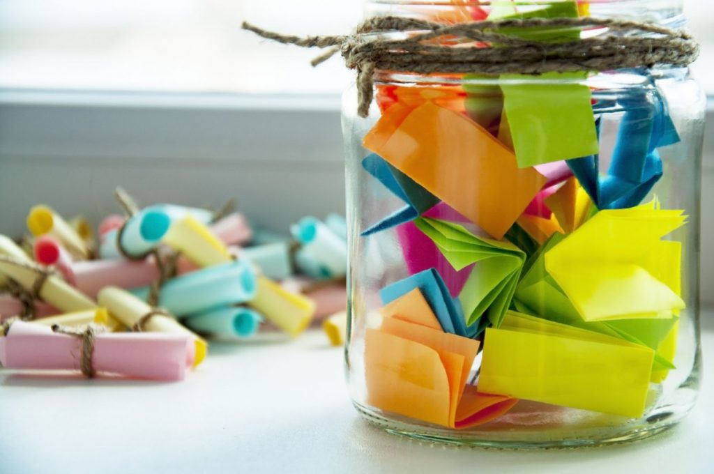 A jar filled with colorful notes