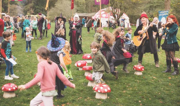 Children playing musical chairs in a halloween party