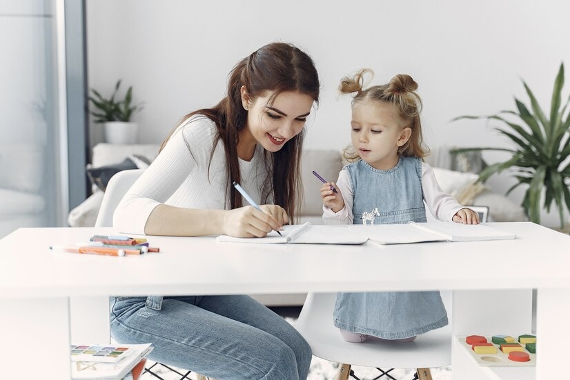 A Little Girl Learning by Doing at Home with a Tutor