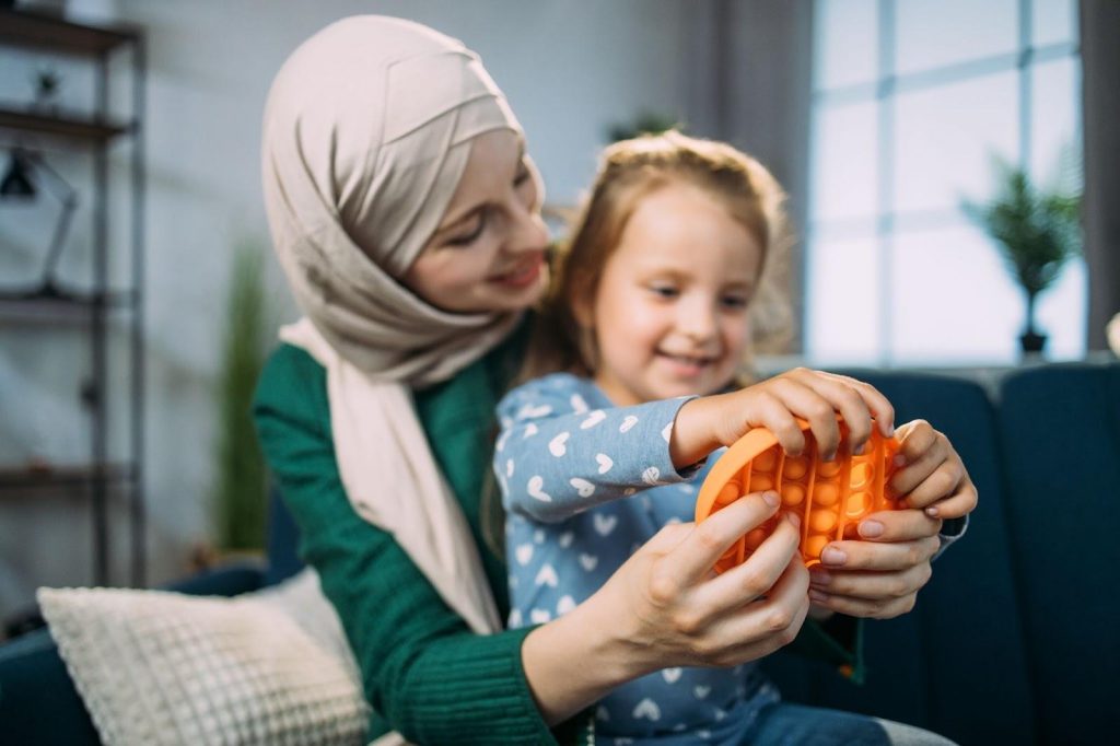 Mother and daughter playing with a sensory object