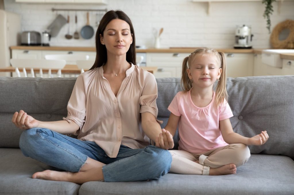 Mother and daughter doing breathing exercise