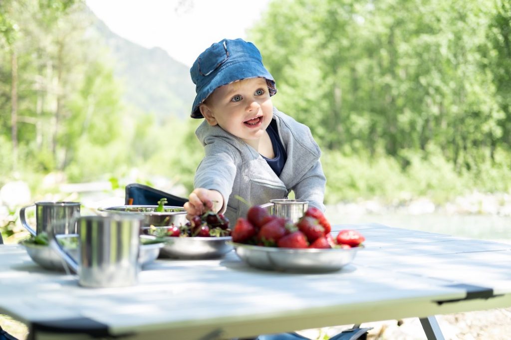 Toddler sitting on a picnic table