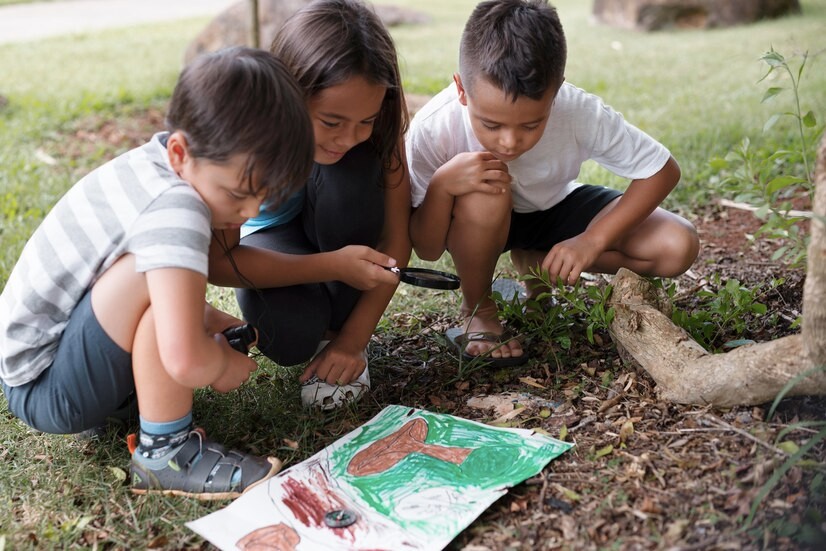 Three children looking at a scavenger hunt map with a lens