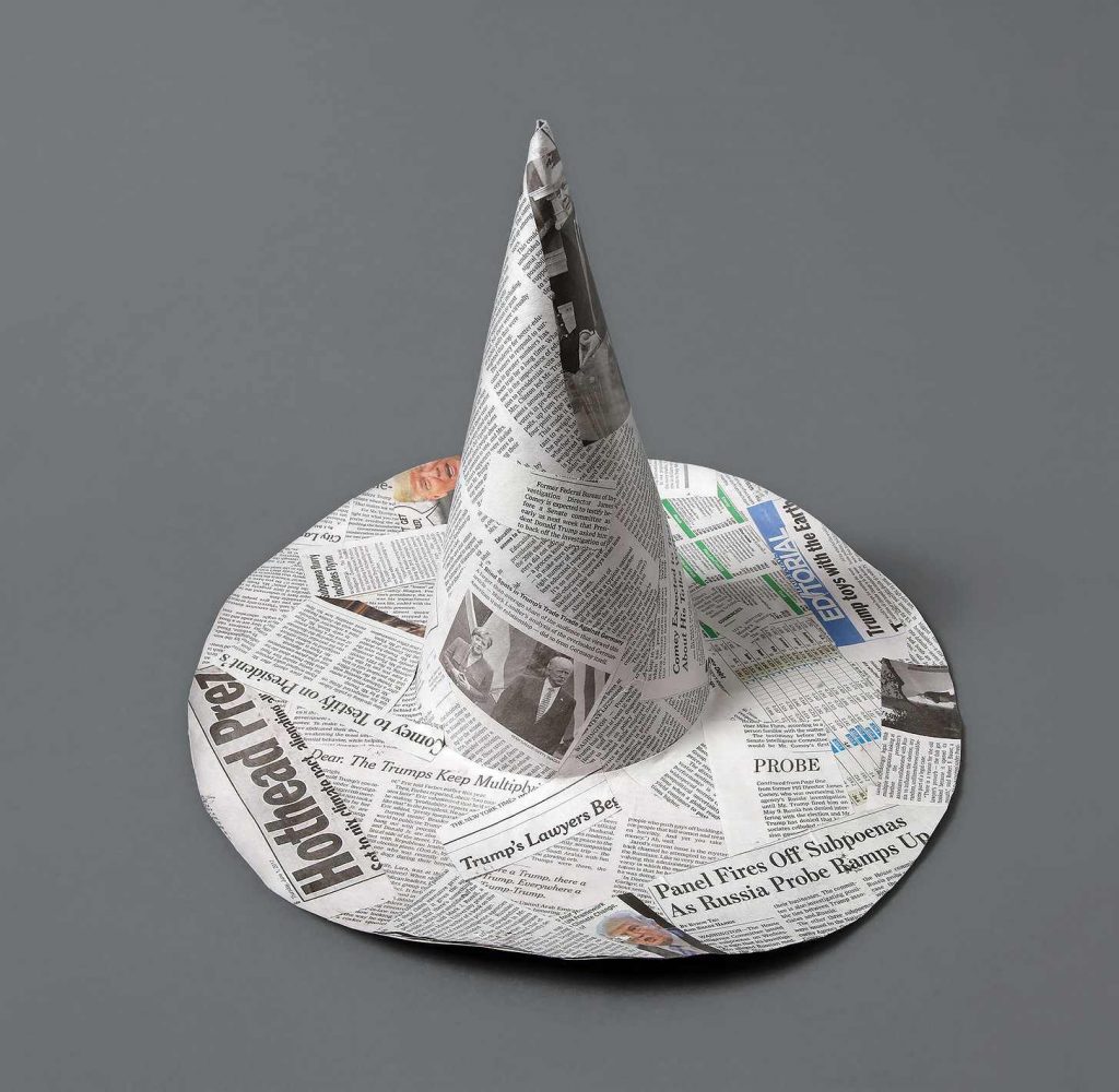 A witch hat made out of newspapers