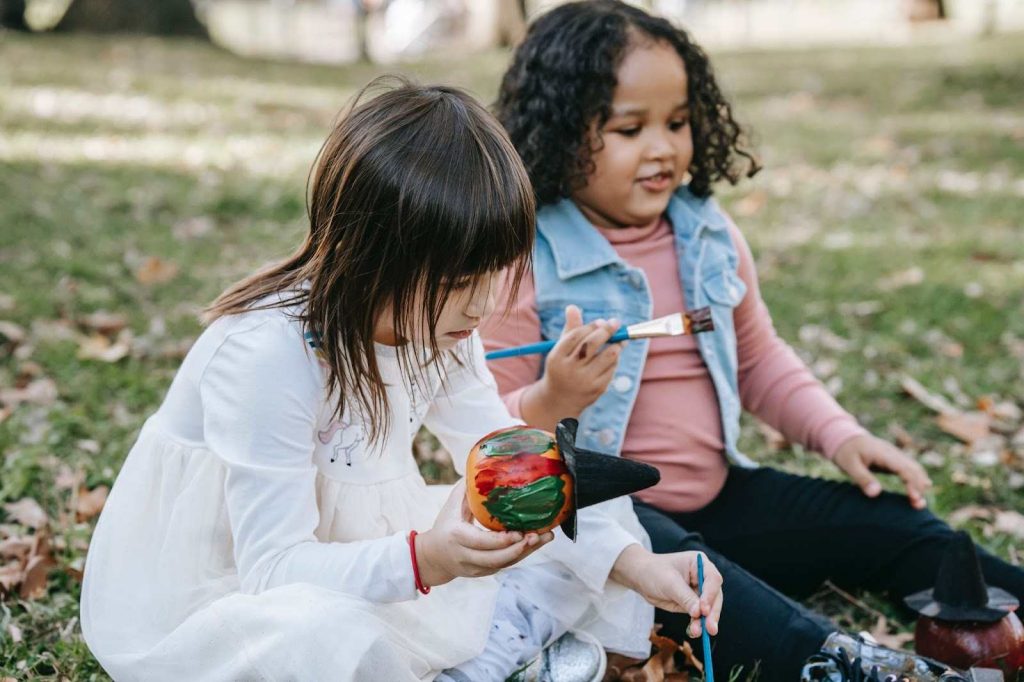 Kids painting pumpkins