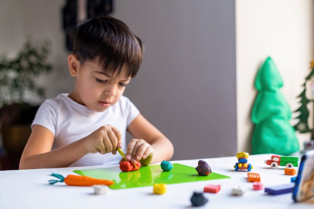 Kid playing with play dough