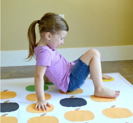 A little girl playing twister